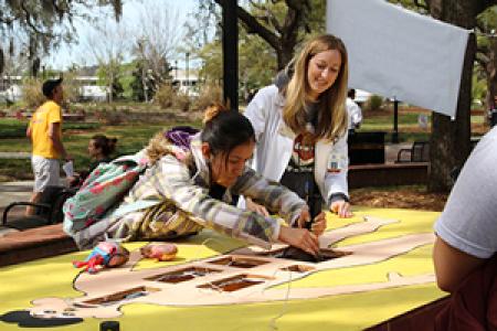 Photo of students participating in a UHS tabling event